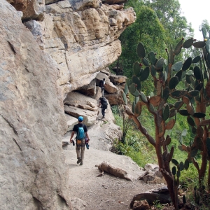 Walking along the base of a wall in Macheta