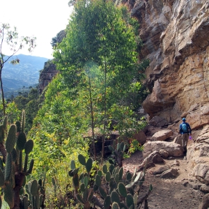 Walking along the base of a wall in Macheta